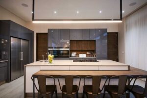 Sleek, minimalist kitchen with a large island and integrated appliances designed for family living.