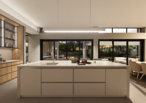 View from behind a white kitchen island showing a built-in sink looking out towards large glass doors and the patio.