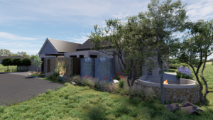 View of the home's dark plaster exterior walls from the side yard, highlighting a curved stone boma wall tucked into the grassy landscaping.