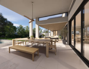View looking down a long, modern covered patio showing large black-framed sliding glass doors leading into the house.