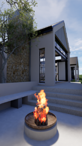 An active wood fire burning in a circular concrete fire pit with steps leading up to the main house structure.