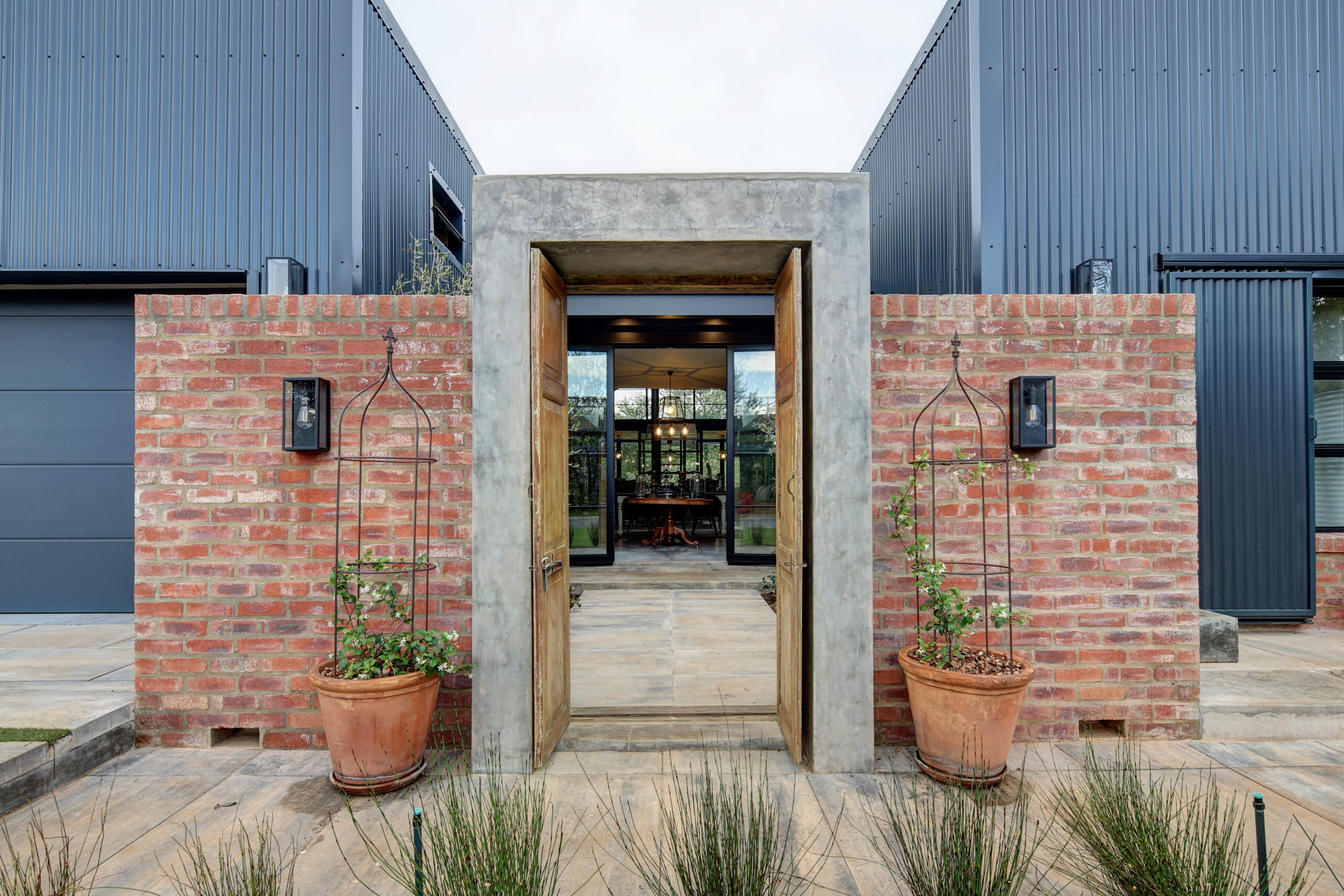 Courtyard Entrance in stock brick and concrete gable with wooden doors